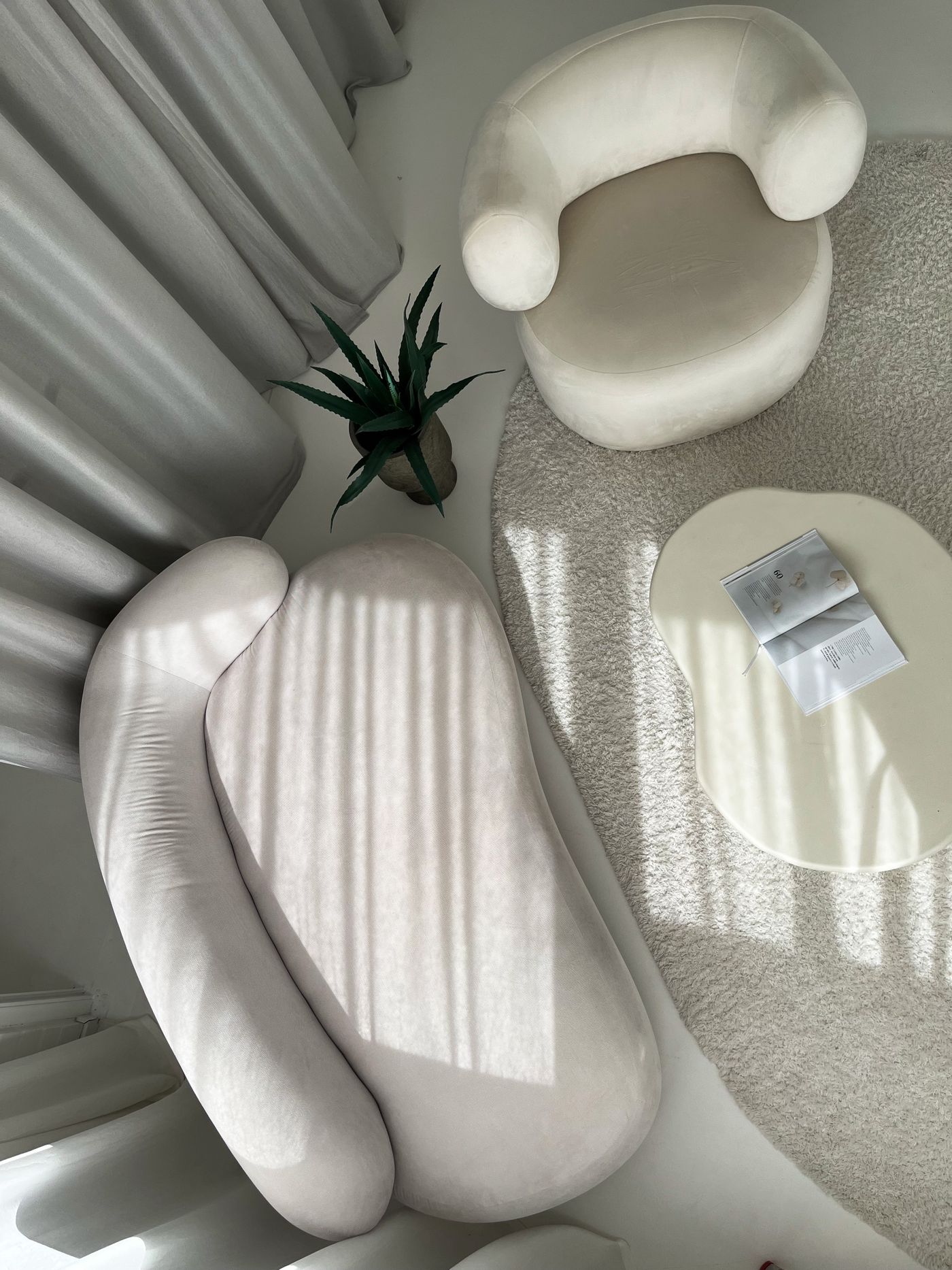 Cream sculptural seating in a neutral living room